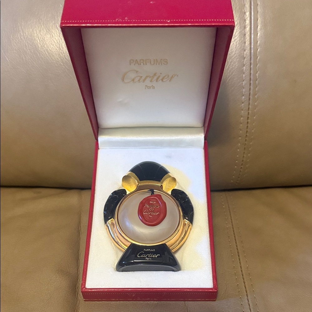 Cartier Perfume bottle in Black/ Gold Design with original red box.Refillable.